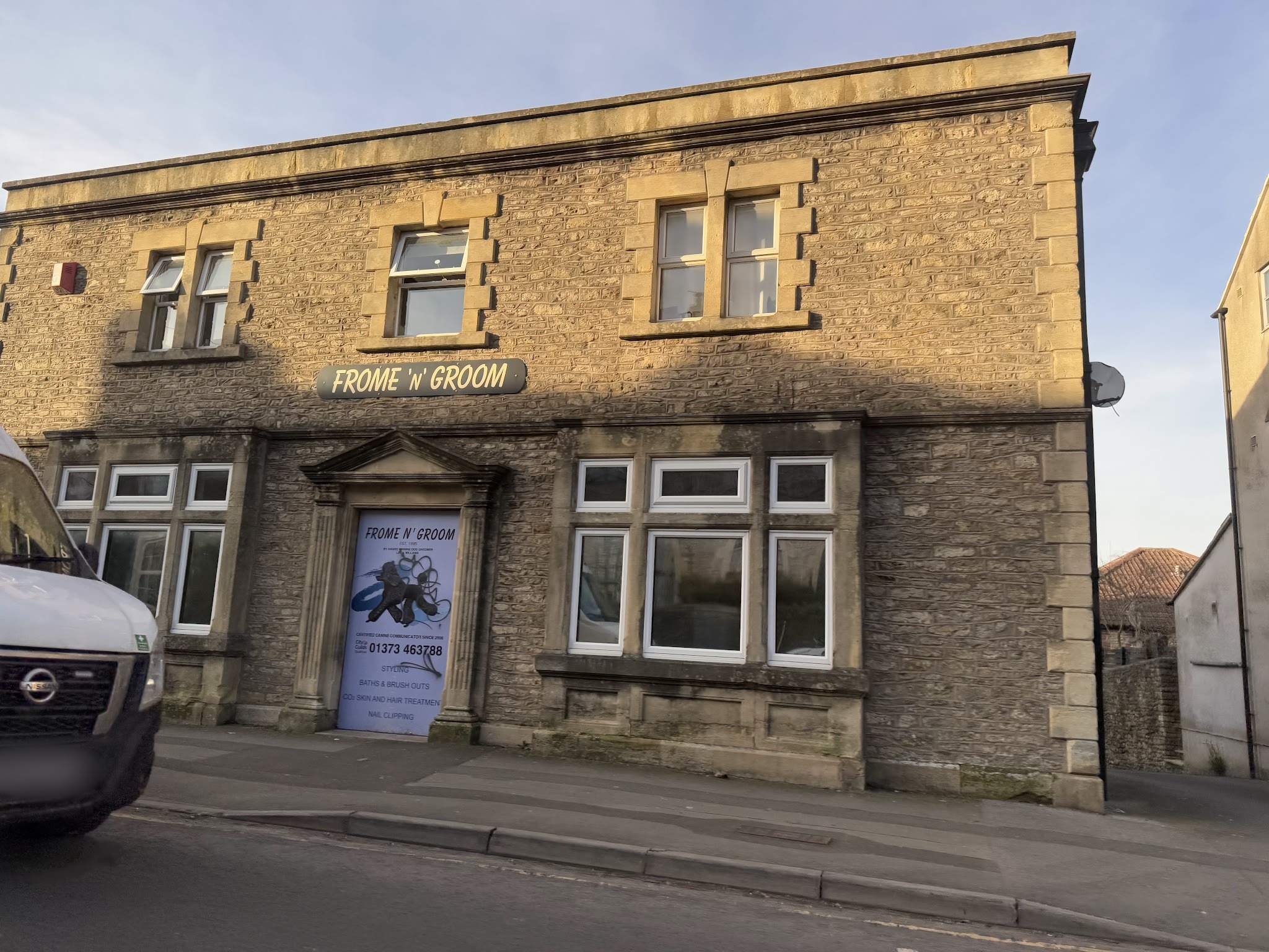 Our shopfront at Victoria House, a stone building with the Frome 'N' Groom sign above the door